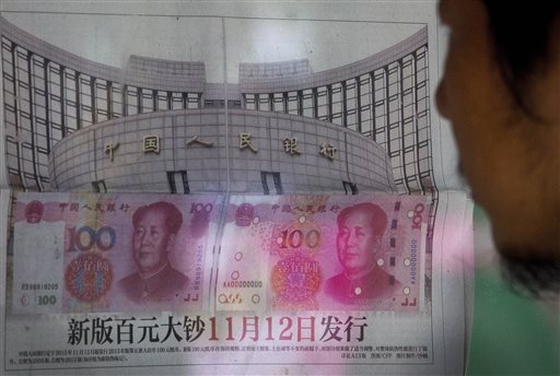 Beijing Tuesday, Aug. 11, 2015. China devalued its tightly controlled currency on Tuesday following a slump in trade, triggering the yuan's biggest one-day decline in a decade. (AP Photo/Andy Wong)