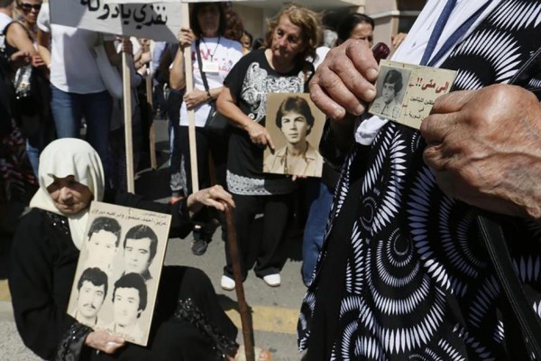 Women hold pictures of relatives who went missing during Lebanon's civil war, which took place from 1975 to 1990, during a protest demanding the government publish any information they have on those who went missing, in front of the government palace in Beirut, Lebanon on September 18, 2014.  © 2014 Reuters
