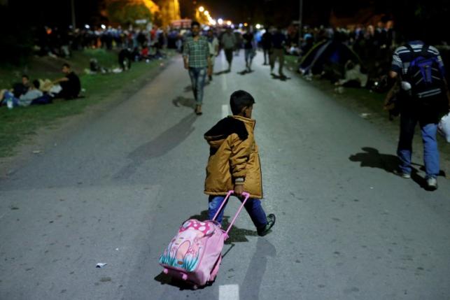 A migrant child crosses the street with a luggage in Tovarnik, Croatia, September 17, 2015. REUTERS/Antonio Bronic