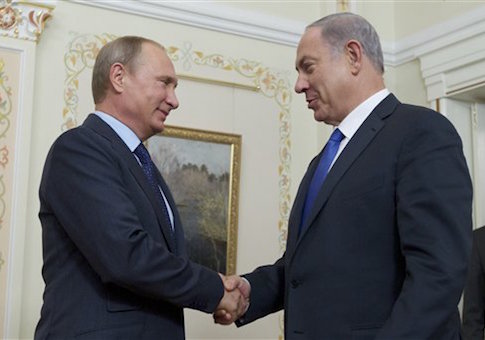 Russian President Vladimir Putin shakes hands with Israeli Prime Minister Benjamin Netanyahu, right, during their meeting in the Novo-Ogaryovo residence, outside Moscow, Russia, Monday, Sept. 21, 2015. (AP Photo/Ivan Sekretarev, Pool)