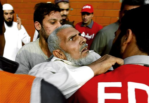 Pakistani rescue workers carry a traumatized person to a hospital in Peshawar, Pakistan, Monday, Oct. 26, 2015. One of Afghanistans most isolated and poverty-stricken regions was hit by a massive earthquake on Monday that reverberated across Asia, shaking buildings from Kabul to New Delhi, cutting power and communications, and killing almost 200 people, mostly in the remote mountain regions near the Afghan-Pakistan border. The number of casualties on both side of the border was expected to rise. (AP Photo/Mohammad Sajjad)