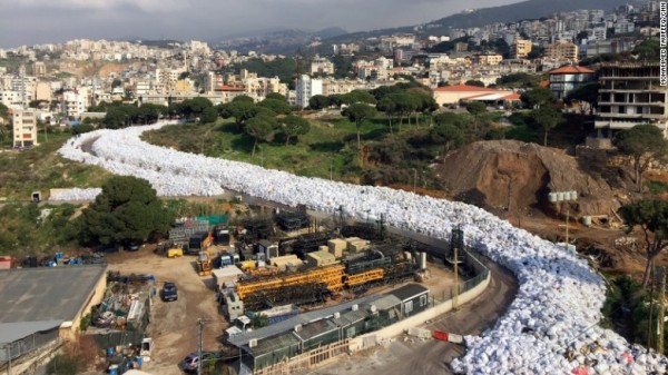 Piles of waste resemble a river  of garbage in Beirut ...  Local governments have been forced to shovel garbage onto the margins of roads and rivers since state authorities closed a major landfill last July without planning for the day after.(AP Photo/Hassan Ammar)