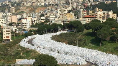 Thousands of tons of household waste, cutting a path through the greenery like a natural river of garbage.