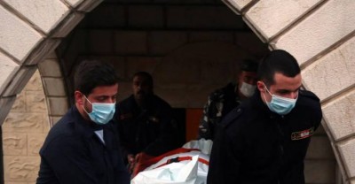 Civil defense workers carry the body of one of two Kuwaiti men into an ambulance in Arayya , Dahr al-Wahesh, Thursday, March 10, 2016.Inn Lebanon