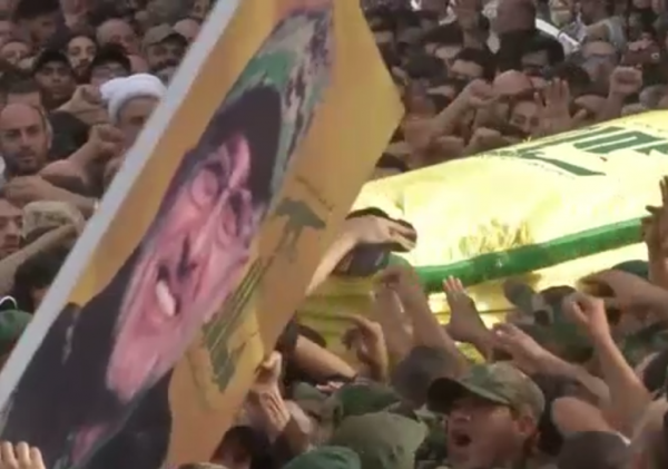 Hezbollah supporters carry the picture of their slain commander Mustafa Badreddine, who was killed in Syria, during his funeral procession in a southern suburb of Beirut, Lebanon Hassan Ammar/AP