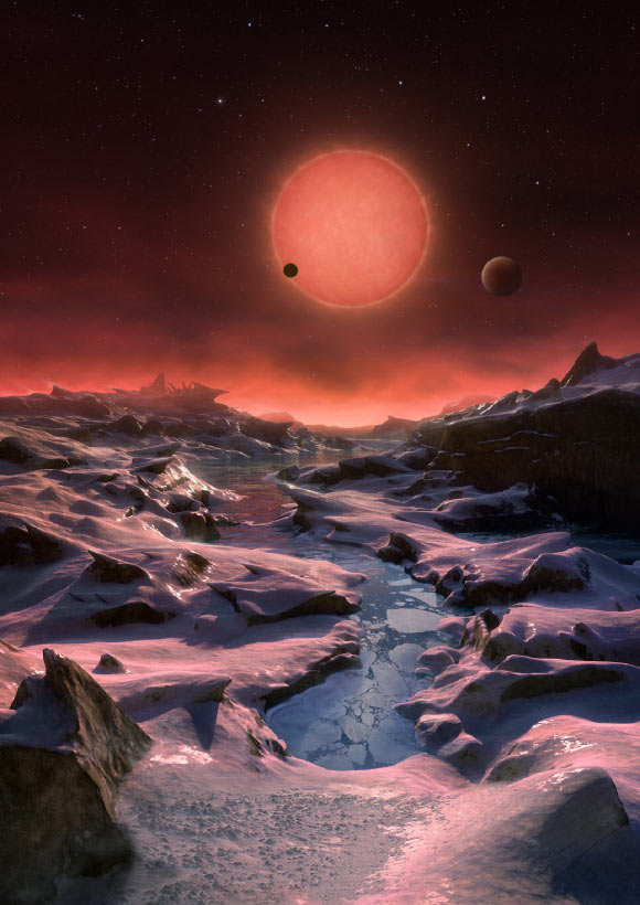 This artist’s impression shows an imagined view from the surface one of the three exoplanets orbiting the ultracool dwarf star TRAPPIST-1 38.8 light-years from Earth. These alien worlds have sizes and temperatures similar to those of Venus and Earth. In this view one of the inner planets is seen in transit across the disc of TRAPPIST-1. Image credit: M. Kornmesser / ESO. This artist’s impression shows an imagined view from the surface one of the three exoplanets orbiting the ultracool dwarf star TRAPPIST-1 38.8 light-years from Earth. These alien worlds have sizes and temperatures similar to those of Venus and Earth. In this view one of the inner planets is seen in transit across the disc of TRAPPIST-1. Image credit: M. Kornmesser / ESO.