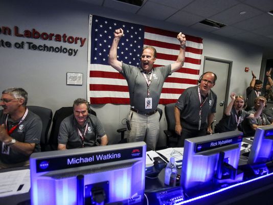 From left to right, Geoffrey Yoder, Michael Watkins, Rick Nybakken, Richard Cook and Jan Chodas celebrate in Mission Control at NASA's Jet Propulsion Laboratory as the solar-powered Juno spacecraft goes into orbit around Jupiter on Monday in Pasadena, Calif. (Photo: Ringo H.W. Chiu, AP)