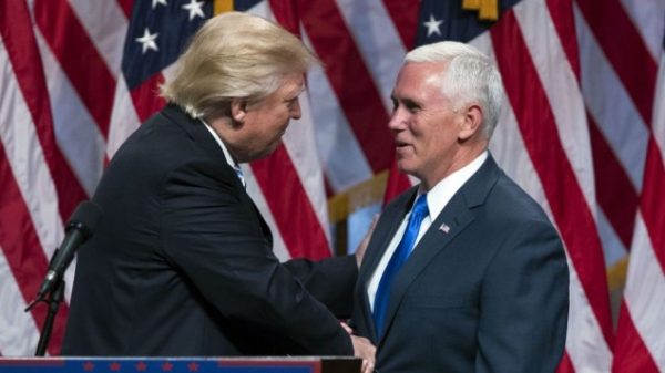 Republican presidential nominee Donald Trump, left, shakes hands with his running mate Gov. Mike Pence,