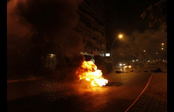 Tires burn on Verdun street after masked men attacked Al-Jadeed TV headquarters in Beirut