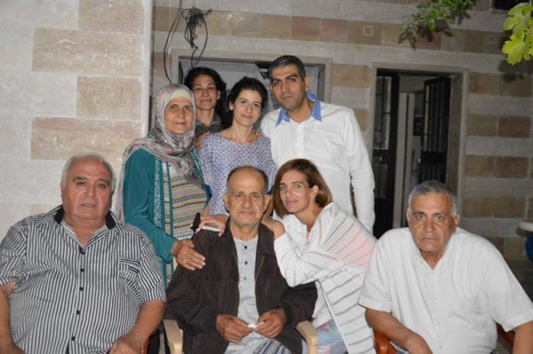 Dr. Saleh al-Shall  (C) is shown with relatives and   friends after his release early Saturday morning (NNA)