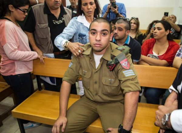 Israeli soldier Elor Azaria, who was caught on video shooting a wounded Palestinian assailant in the head as he lay on the ground, sits during a hearing at a military appeals court in Tel Aviv during which he was charged with manslaughter. (JACK GUEZ/AFP/GETTY IMAGES)