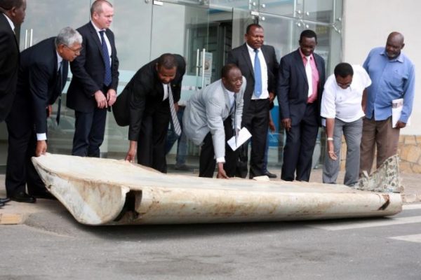 Tanzania Permanent Secretary to the ministry of Works, Transport and Communication Leonard Chamuriho (C) hands over of a wing suspected to be a part of missing Malaysia Airlines jet MH370 discovered on the island of Pemba, off the coast of Tanzania, in Dar es Salaam, Tanzania July 15, 2016. With him are Australia High Commissioner to East African John Feakes (2ndL) and Ministry of Transport Malaysian Senior Accident investigator Aslam Basha Kham (L).  REUTERS/Stringer