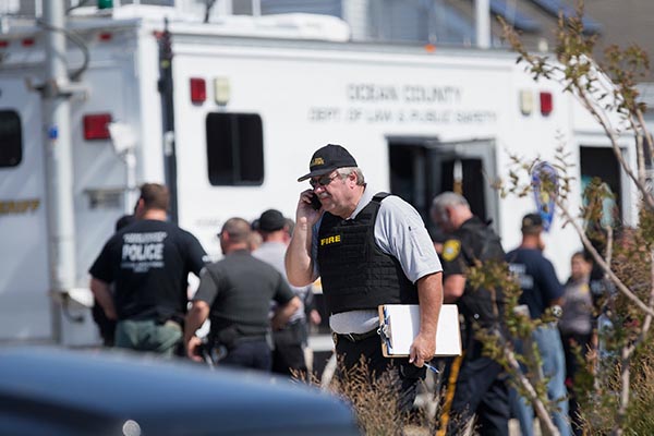 Police gather at a command center in Seaside Park, N.J., on Saturday, Sept. 17, 2016, during an investigation of a pipe bomb which exploded before a charity race to benefit Marines and sailors. No injuries were reported. Peter Ackerman/The Asbury Park Press via AP