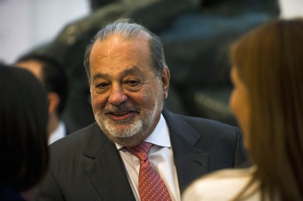 Lebanese-Mexican billionaire Carlos Slim Helu greets attendees before speaking about a new educational application during a news conference at the Museo Soumaya in Mexico City, Wednesday, June 15, 2016. The application, titled Aprende, is free and is currently in use. Nick Wagner / AP