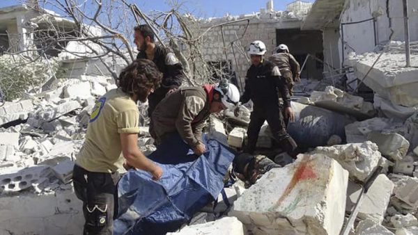 In this photo provided by the Syrian Civil Defense group known as the White Helmets, Syrian Civil Defense workers search through the rubble after airstrikes in the village of Hass in the Idlib province, Syria, on Oct. 26, 2016. Syrian activists say that airstrikes outside a school in the northern, rebel-held province of Idlib have killed 17 people, mostly children. The Idlib News network says the airstrikes hit as the children gathered outside a school complex in the village of Hass. (Syrian Civil Defense White Helmets / AP)
