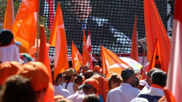 Supporters of Christian leader Michel Aoun hold flags as he speaks via video link during a rally near the presidential palace in the Beirut suburb of Baabda, Lebanon, Sunday, Oct. 16, 2016. Aoun said that respecting Lebanon's equal power sharing system between Christians and Muslims will pave the way for building a proper state. (AP Photo/Hassan Ammar)  (The Associated Press)