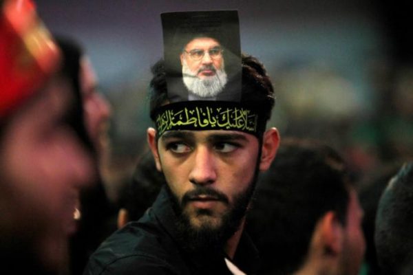 A supporter of Lebanon's Hezbollah leader Sayyed Hassan Nasrallah has his picture on his head during a public appearance by Nashrallah at a religious procession, one day before the Shi'ites will mark the day of Ashura, in Beirut's southern suburbs, Lebanon October 11, 2016. REUTERS/Aziz Taher