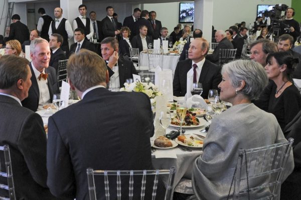 Russian President Vladimir Putin, center right, sits with retired Lt. Gen. Michael T. Flynn, center left, at a dinner in Moscow in 2015.  Putin  who favored Donal Trump was accused of manipulating the US election by hacking Hillary Clinton's campaign . (Mikhail Klimentyev/Pool photo by Sputnik via AP)