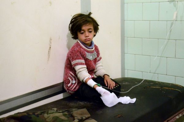 An injured child waits after receiving treatment at the university hospital in a government-held neighborhood on Nov. 3, following reported rebel fire on government-held parts of the northern city of Aleppo. (GEORGE OURFALIAN/Agence France-Presse via Getty Images)