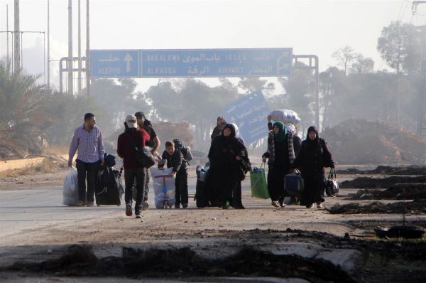 Syrians carry their belongings as they leave Aleppo on Sunday. OMAR HAJ KADOUR / AFP - Getty Images