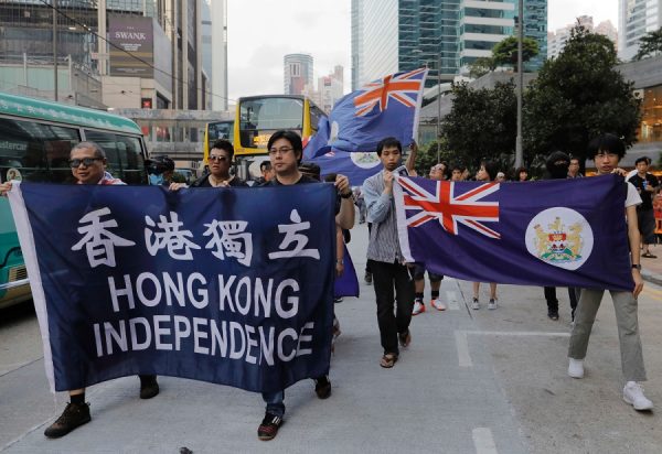 Protesters use umbrellas to block the pepper spray from  officers outside the Chinese central government's liaison office in Hong Kong, Sunday, Nov. 6 , 2016