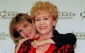 Debbie Reynolds is hugged by her daughter Carrie Fisher