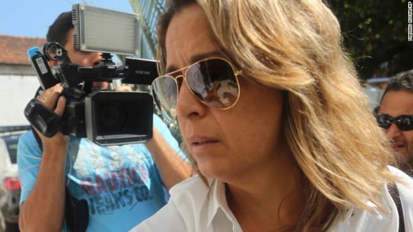 Francoise De Souza Oliveira arrives at a police station on Friday to be questioned.