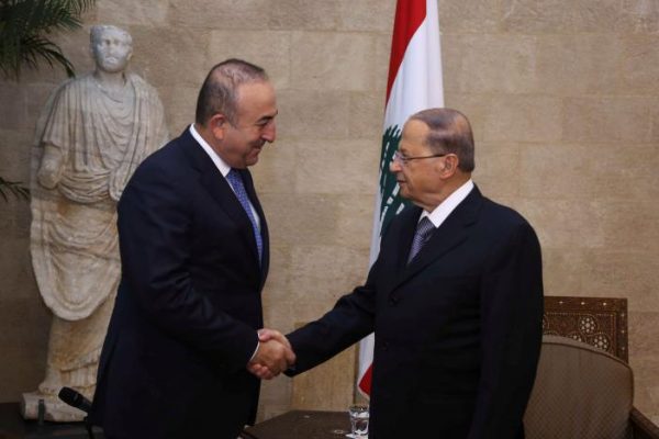 Lebanon's President Michel Aoun shakes hands with Turkey's Foreign Minister Mevlut Cavusoglu (L) in the presidential palace in Baabda, in this handout picture released by Dalati Nohra, December 2, 2016. Dalati Nohra/Handout via Reuters