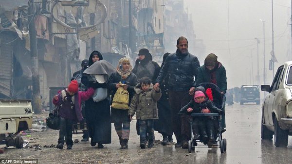 Rebel groups have announced a ceasefire in Aleppo after Syrian forces were accused of 'massacring 82 civilians in their homes' during 'the century's worst humanitarian tragedy'. Families were seen fleeing this afternoon 
