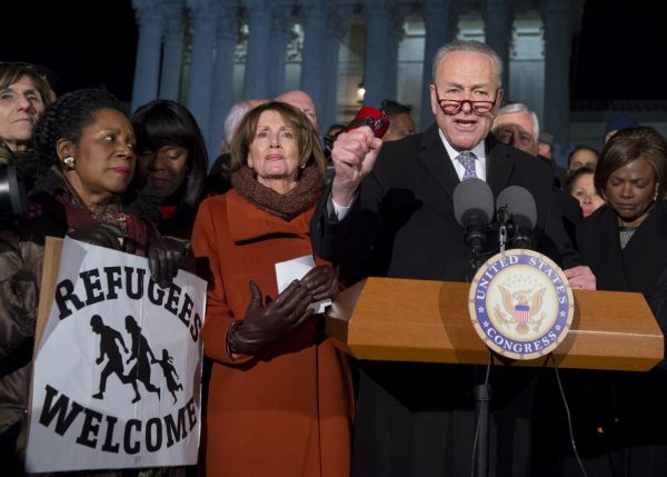 Senate Minority Leader Chuck Schumer (D-N.Y) speaks alongside House Minority Leader Nancy Pelosi (D-Calif.) and other members of Congress as demonstrators protest against President Trump and his administration's ban of refugees from around the world and foreign nationals from seven Muslim-majority countries. (Saul Loeb/AFP/Getty Images)