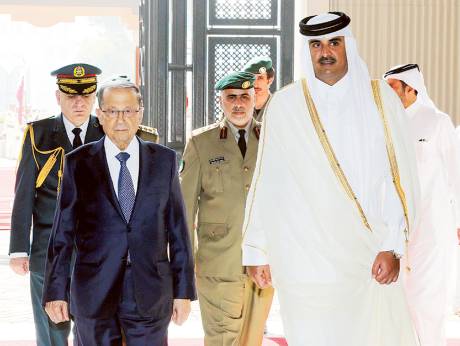 A handout picture provided by the Lebanese photo agency Dalati and Nohra on Wednesday shows Emir of Qatar Shaikh Tamim Bin Hamad Al Thani welcoming Lebanese President Michel Aoun upon his arrival in Doha.