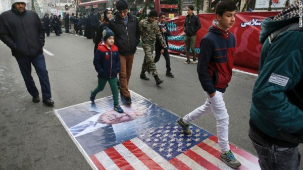 Iranian President Hassan Rouhani has warned that Iran will not be bullied by those using "threatening language" against the regime. Iranians shown marching on a portrait of Trump in Tehran on Friday. 
