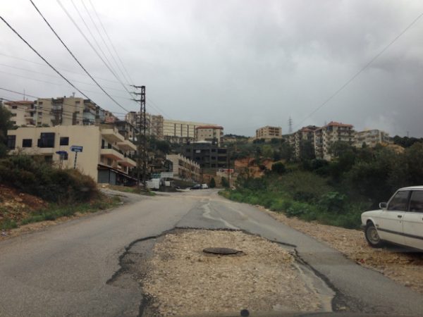 A main road in Batroun district . Potholes  spring up out of nowhere on  Lebanon's road 