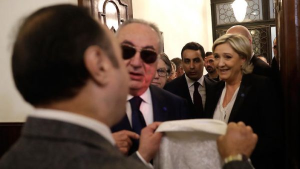 An aide of Lebanon's Grand Mufti Sheikh Abdel-Latif Derian, left, gives a head scarf to French far-right presidential candidate Marine Le Pen (right) who arrived Monday in Beirut, , to wear during her meeting with the Mufti but she refused, upon her arrival at Dar al-Fatwa the headquarters of the Sunni Mufti, in Beirut, Lebanon, Tuesday, Feb. 21, 2017. The meeting was canceled. Le Pen Stirred controversy in Lebanon over the headscarf issue and Syrian president Bashar Al Assad Assad whom she supports as " the lesser evil " (AP Photo/Hussein Malla)