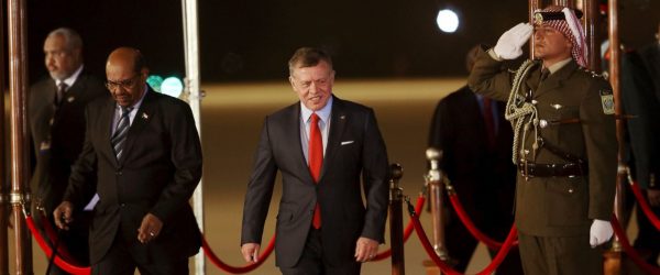 Jordan's King Abdullah II, center, greets Sudan's President Omar al-Bashir, left, upon his arrival at Queen Alia International Airport in Amman, Jordan, Tuesday, March 28, 2017. Sudan's president, sought by the International Criminal Court on war crimes charges, has been welcomed in Jordan, despite calls by human rights groups to deny him entry. Omar al-Bashir is among 21 Arab leaders gathering for a summit. (AP Photo/Raad Adayleh)