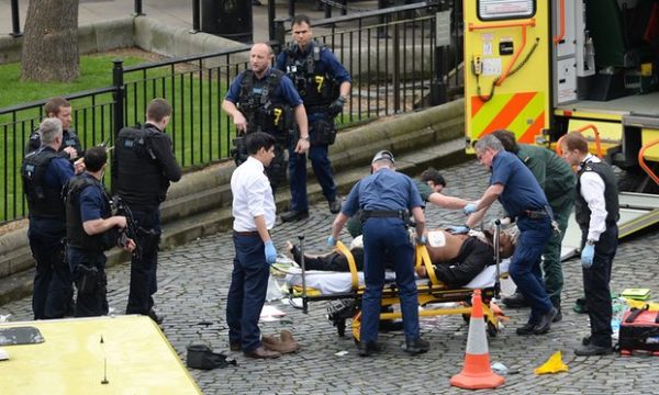 The suspected attacker is treated by emergency services at the scene outside the Palace of Westminster. Photograph: Stefan Rousseau/PA