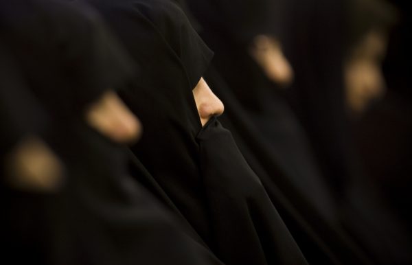 Iranian women dressed in  black chadors