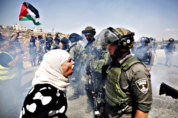 A Palestinian woman argues with an Israeli policeman during a protest against illegal Jewish settlements in the West Bank village of Nabi Saleh, near Ramallah...