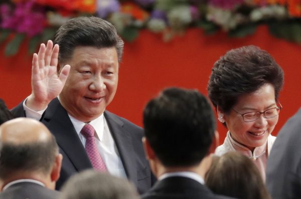 China's President Xi Jinping warns Hong Kong to toe the line as he swears in first female leader, Carrie Lim