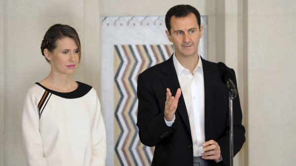 Syria's President Bashar al-Assad stands next to his wife Asma. US Secretary of State Rex Tillerson repeated the U.S. position that a “long-term role for the Assad family and the Assad regime” is untenable 
