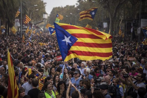 People celebrate the unilateral declaration of independence of Catalonia outside the Catalan Parliament, in Barcelona, Spain, Friday, Oct. 27, 2017. Catalonias’ regional Parliament passed a motion Friday to establish an independent Catalan Republic. (AP Photo/ Emilio Morenatti)