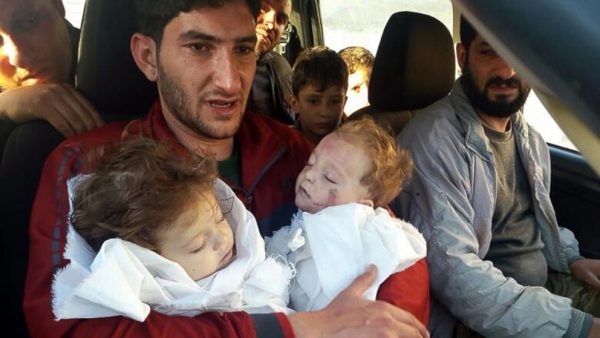 Abdel Hameed al-Youssef cradles the bodies of his nine month old twins after they were killed in a suspected chemical attack on Idlib in Syria on April 4, 2017.