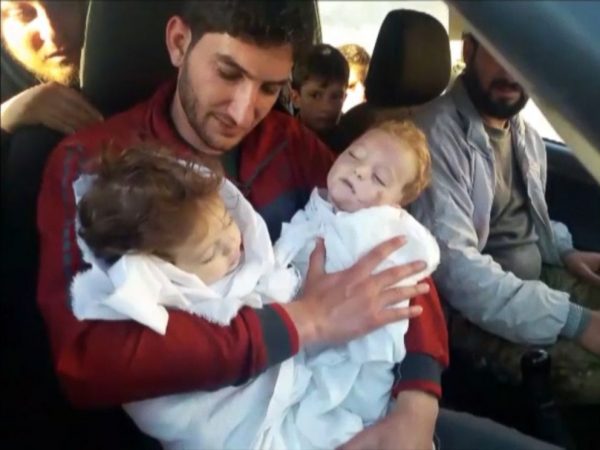 Abdel Hameed al-Youssef cradles the bodies of his nine month old twins after they were killed in a suspected chemical attack on Idlib in Syria on April 4, 2017.