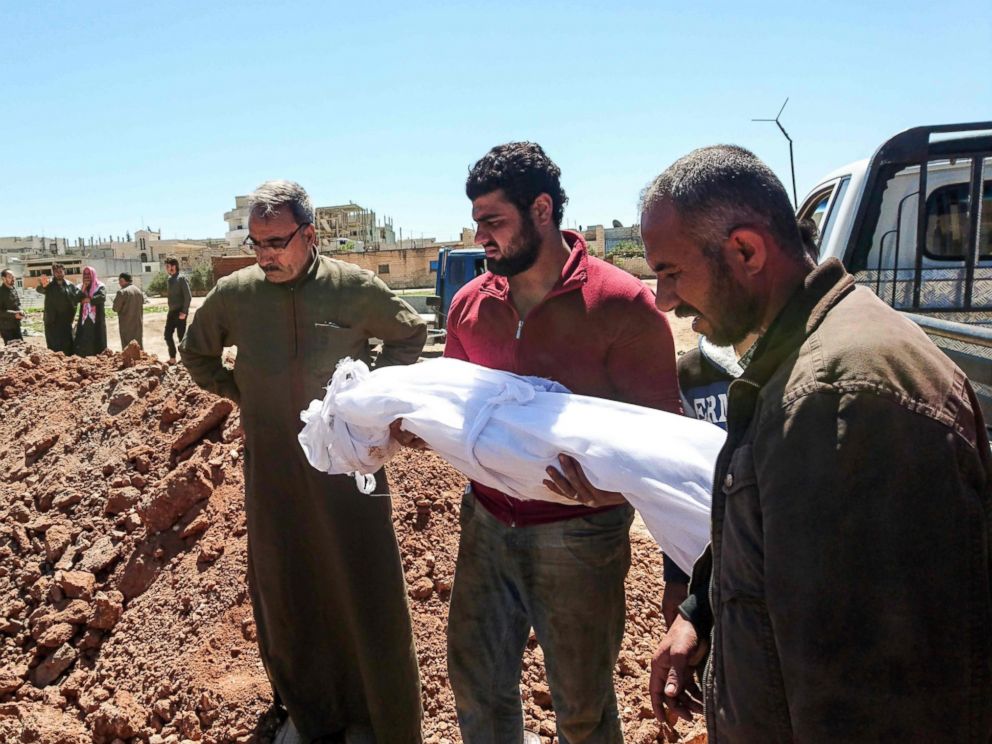 Syrians bury the bodies of victims of a a suspected toxic gas attack in Khan Sheikhun, a nearby rebel-held town in Syria's Idlib province, April 5, 2017.