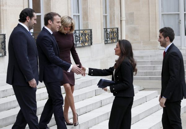 French President Emmanuel Macron, second left, and his wife Brigitte, centre left, greet Lebanon's Prime Minister Saad Hariri, left, his wife Lara, center center and their son Hussam, right, upon their arrival at the Elysee Palace in Paris, Saturday, Nov. 18, 2017. Hariri arrived in France on Saturday from Saudi Arabia and may be back in Beirut next week, seeking to dispel fears that he had been held against his will and forced to resign by Saudi authorities.(AP Photo/Christophe Ena)