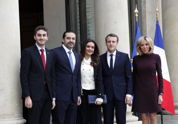 French President Emmanuel Macron, center right, and his wife Brigitte, right, greet Lebanon's Prime Minister Saad Hariri, second left, his wife Lara, center left and their son Hussam upon their arrival at the Elysee Palace in Paris, Saturday, Nov. 18, 2017. Hariri arrived in France on Saturday from Saudi Arabia and may be back in Beirut next week, seeking to dispel fears that he had been held against his will and forced to resign by Saudi authorities.(AP Photo/Christophe Ena)