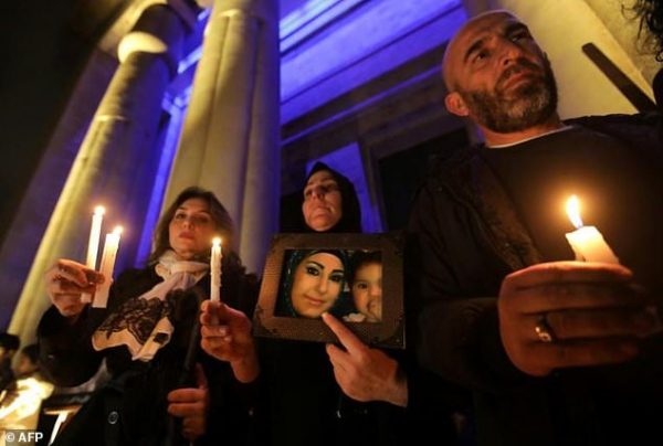Lebanese activists take part in a candle vigil to denounce violence against women outside Beirut's National Museum on December 23, 2017