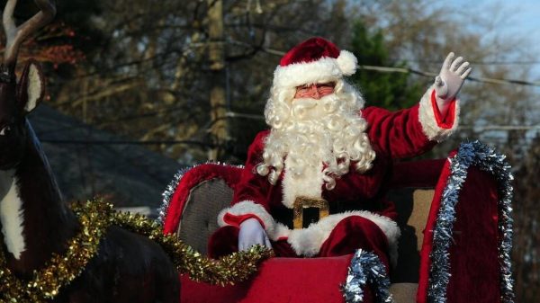 Santa waves to the crowds from his sleigh in the Cary Jaycees Christmas Parade, which took place on Saturday, December 12, 2015 in Cary, NC 
