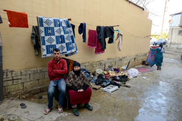 A Syrian refugee mother and son outside their shelter in Ghazieh, Saida, Lebanon.  © UNHCR/Sebastian Rich