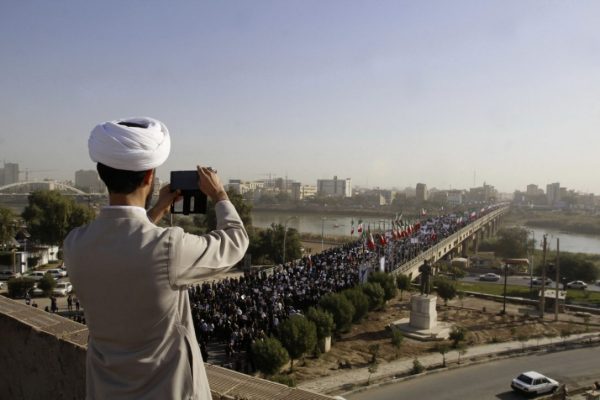 A clergyman takes a picture of a pro-government demonstration in the southwestern city of Ahvaz, Iran, Wednesday, Jan. 3, 2018. Iranian state media reported that pro-government demonstrations were once again held across the country Saturday. (MOHAMMAD AHANGARI / IRANIAN STUDENTS' NEWS AGENCY/THE ASSOCIATED PRESS) 